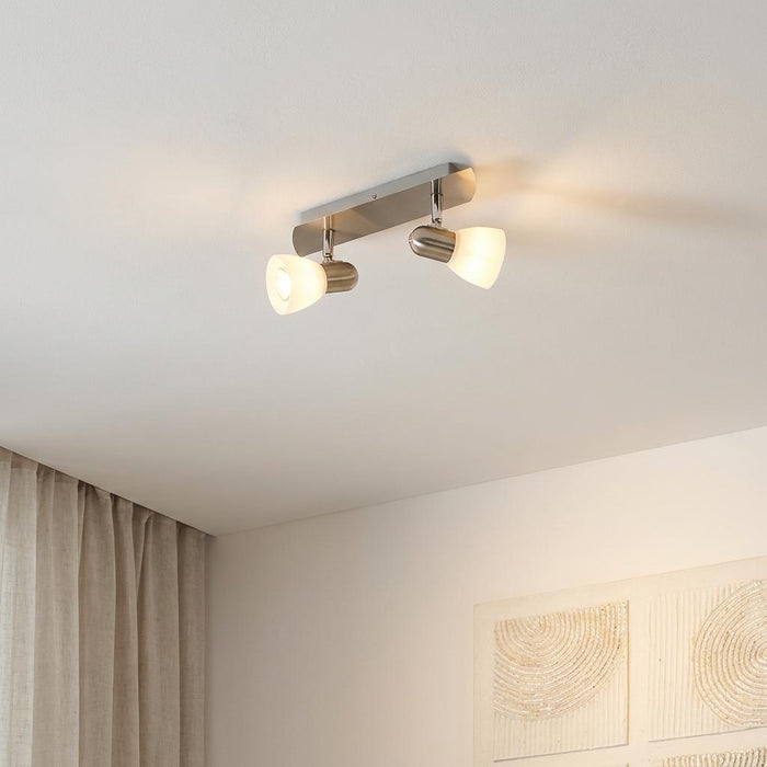 Eglo Enea 2-light bar spotlight with nickel finish and white satin glass shades, mounted on a white ceiling.
