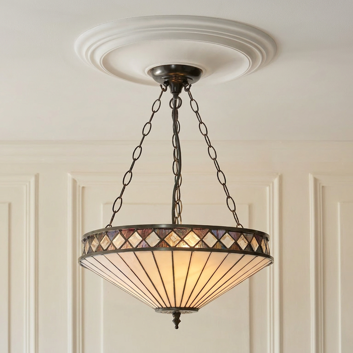Inverted Tiffany ceiling light with Art Deco geometric glass panels suspended from a white ceiling rose.