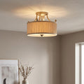 Feiss Abbey semi-flush gold ceiling light with a pleated fabric shade in a warm, neutral room setting.