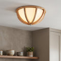 Feiss Allier flush mount light with curved wooden ribs and a frosted glass shade installed in a neutral kitchen.