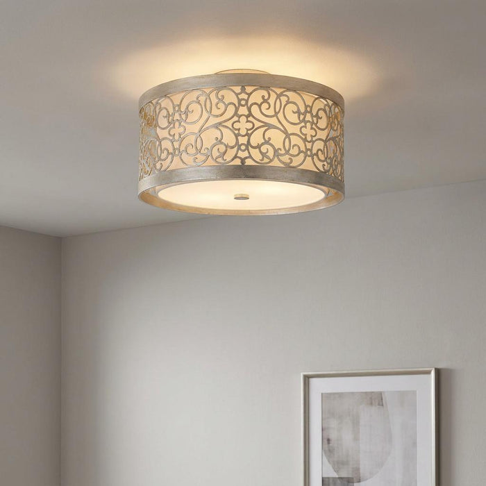 Feiss Arabesque silver leaf 2 light ceiling flush mount with ornate scrollwork over an ivory linen shade.