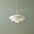 Feiss Brisbin 1 light matte white tiered pendant ceiling light illuminated against a sage green wall.