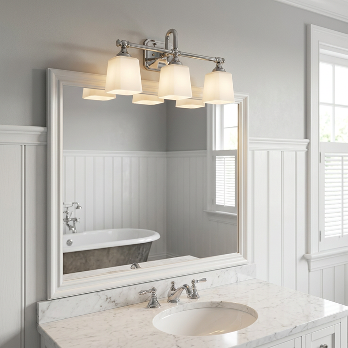 Feiss Concord Chrome 3 Light Bathroom Wall Light with white glass shades above a marble vanity mirror.
