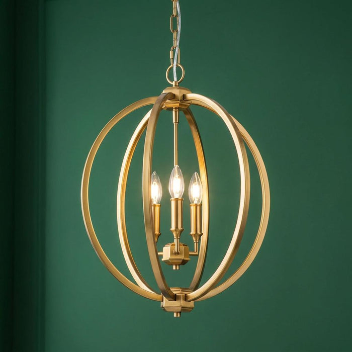 Modern brass orb pendant light with three candle bulbs against a dark green wall.