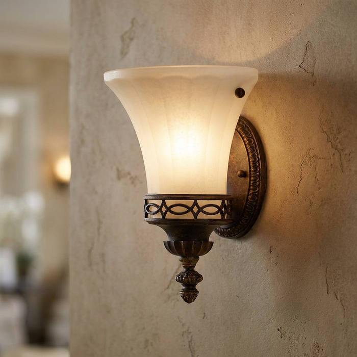 Feiss Drawing Room walnut wall uplighter with a frosted scalloped glass shade mounted on a textured wall.