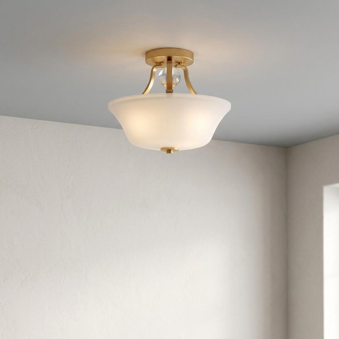 Feiss Evington two-light semi-flush gold ceiling light featuring a frosted white glass bowl shade.