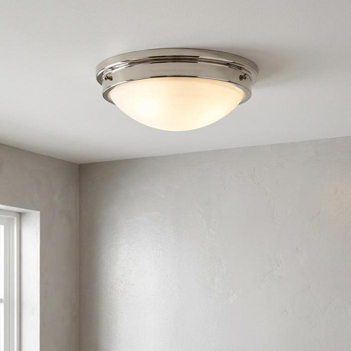 Feiss Gravity 2 light flush polished nickel ceiling light with a white frosted glass bowl on a white ceiling.