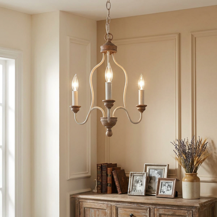 Feiss Hartsville 3-light chandelier in chalk washed beechwood hanging above a rustic wooden sideboard.