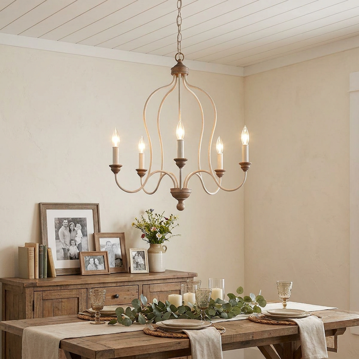 Feiss Hartsville 5-light chandelier in chalk washed beechwood hanging over a rustic dining table.