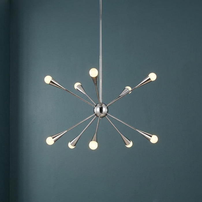 Feiss Jax 10-light polished nickel Sputnik chandelier with glowing globe bulbs against a dark teal wall.