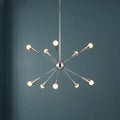 Feiss Jax 10-light polished nickel Sputnik chandelier with glowing globe bulbs against a dark teal wall.