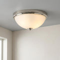 Feiss Malibu flush mount ceiling light with polished nickel trim and a frosted white glass bowl shade.