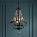 Feiss Nori four-light zinc and wood bead chandelier with lit bulbs against a dark blue paneled wall.