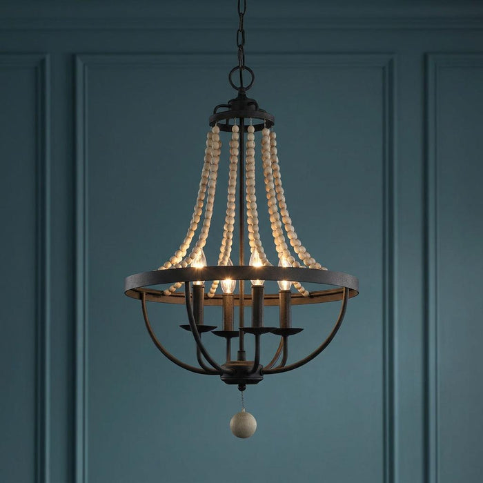 Feiss Nori four-light zinc and wood bead chandelier with lit bulbs against a dark blue paneled wall.