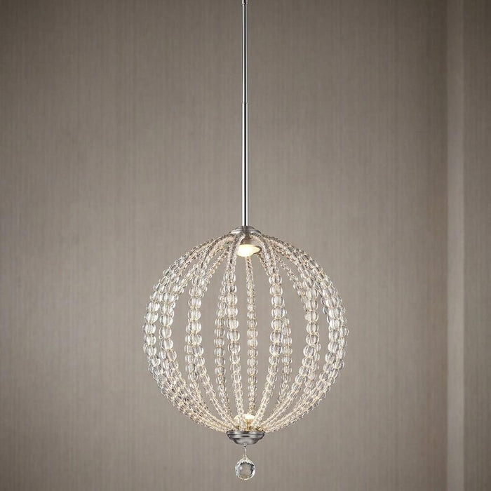 Satin nickel LED pendant light with a spherical frame draped in clear glass beads against a neutral textured wall.