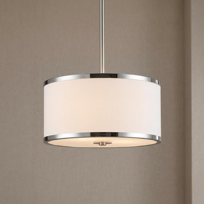 Chrome semi-flush ceiling light with a white fabric drum shade emitting a warm glow against a neutral wall.