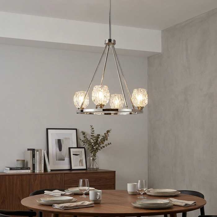 A Feiss Rubin 4-light chandelier in polished nickel with textured glass shades hanging above a wooden dining table.