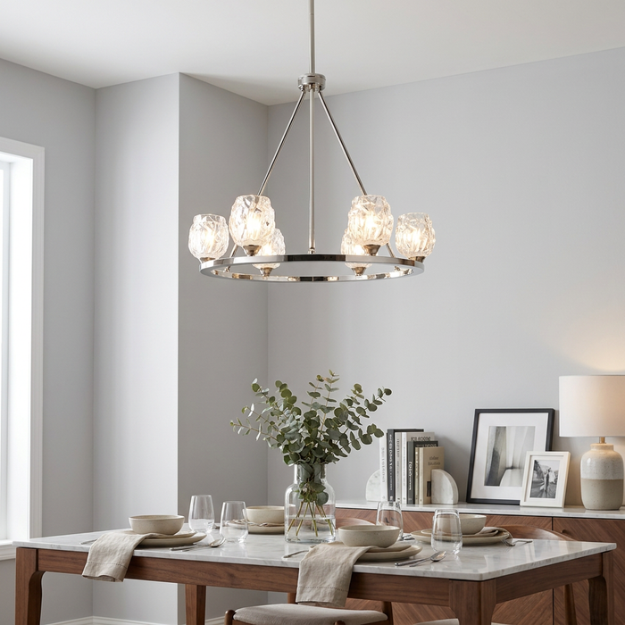 Polished nickel Feiss Rubin 6-light chandelier with textured glass shades hanging above a set dining table.