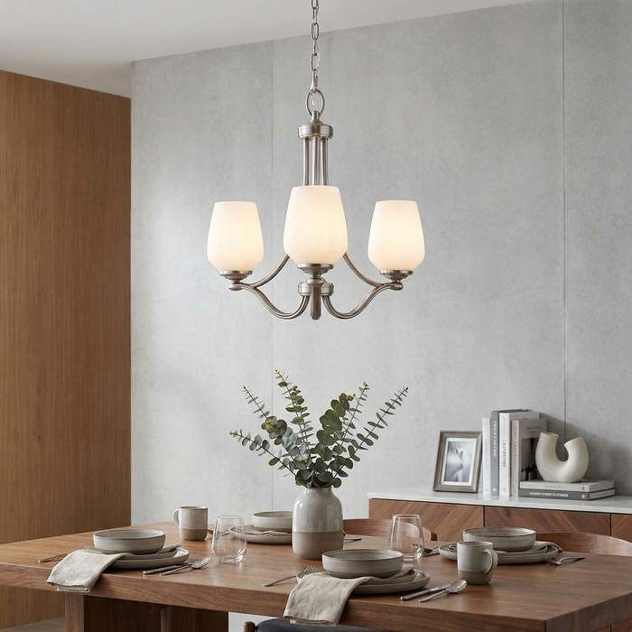 Feiss Vintner 3 Light Chandelier in satin nickel with opal glass shades hanging over a set dining table.