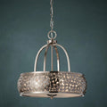 Feiss Zara 4 light brushed nickel pendant light with a mosaic drum shade and curved cage against a blue wall.