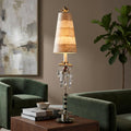Flambeau Birdland table lamp with a tall striped shade and crystal accents on a wooden table in a living room.