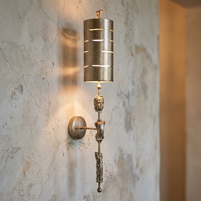 Flambeau Fragment silver sconce with a sculptural stem and slotted cylindrical shade mounted on a distressed wall.