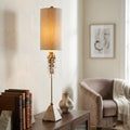 Flambeau Madison table lamp with a tall tan shade, crystal accents, and a putty patina base on a wooden table.