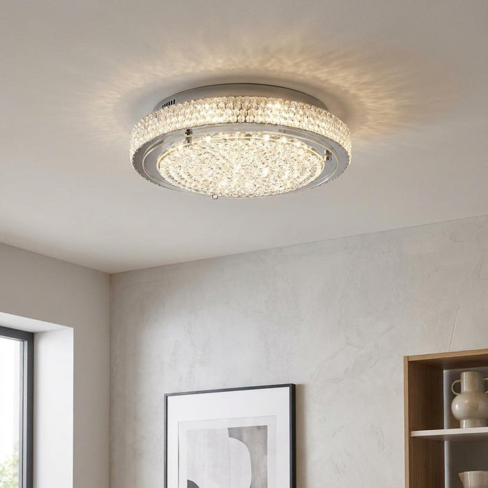 Florida chrome and crystal flush LED ceiling light illuminated on a white ceiling in a modern interior.