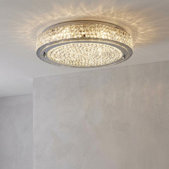 Florida Chrome & Crystal flush LED ceiling light illuminated on a white ceiling, casting a sparkling glow.