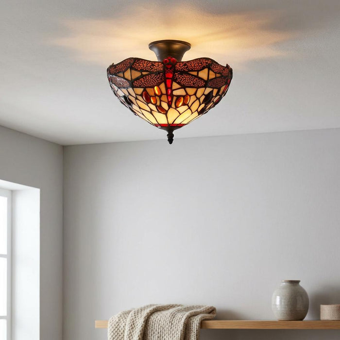 Tiffany dragonfly stained glass semi-flush ceiling light with red and amber details on a white ceiling.