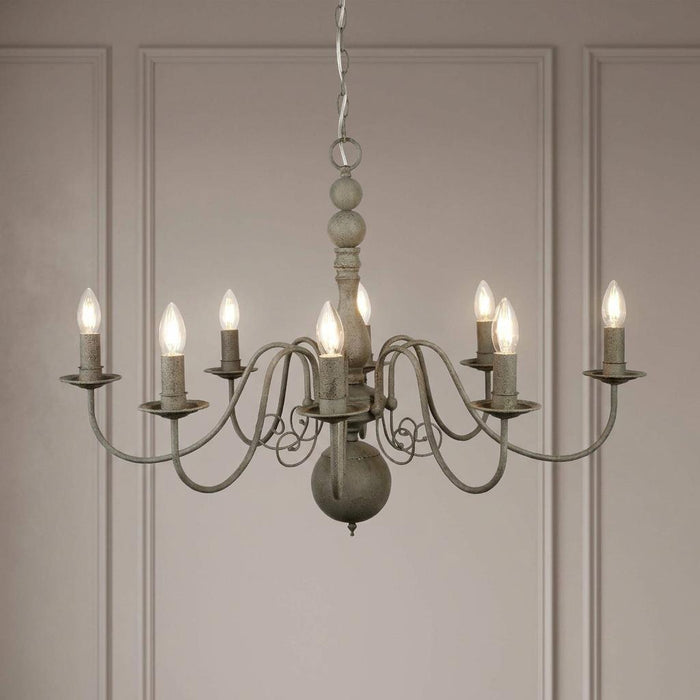 Eight-light Greythorne chandelier with a textured grey finish and curved arms against a paneled wall.