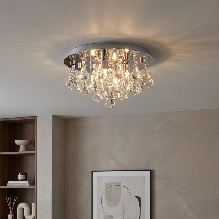 Hanna crystal and chrome flush ceiling light with glowing teardrop crystals in a modern interior.