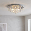 Hanna 6 Light Pyramid Crystal and Chrome Flush Ceiling Light glowing in a modern neutral room.
