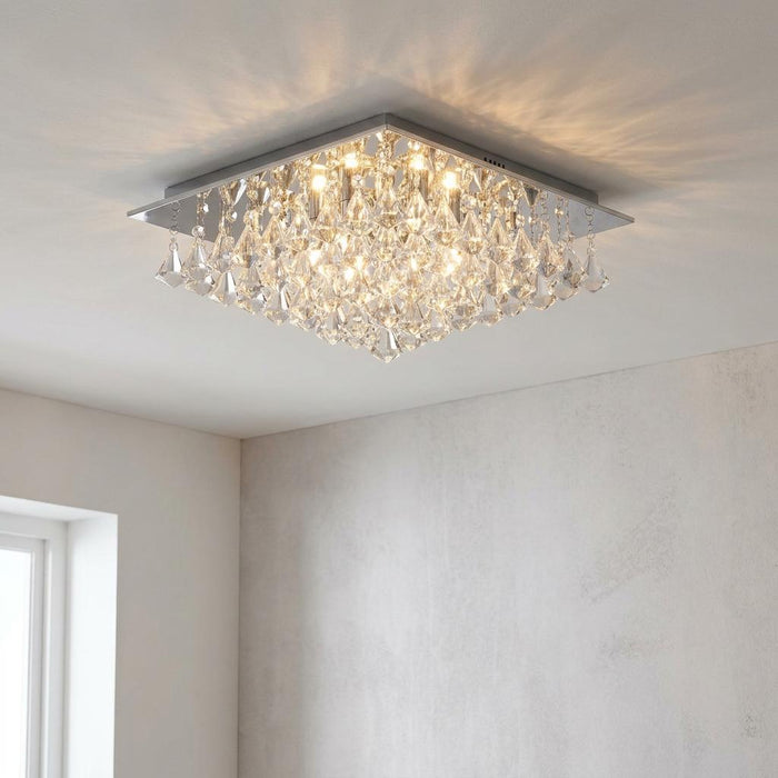 Illuminated Hanna 6 light square chrome and crystal pyramid flush ceiling light in a neutral room.