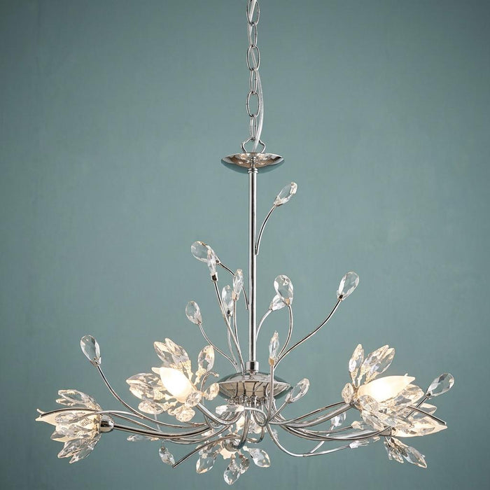 Hibiscus 5 light chrome and crystal ceiling pendant with floral crystal accents against a blue background.