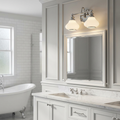 Polished chrome two-light vanity fixture with opal glass shades mounted above a bathroom mirror.
