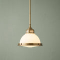 Hinkley Amelia 1 light mini pendant in brass with a dome-shaped white glass shade and industrial hardware accents.