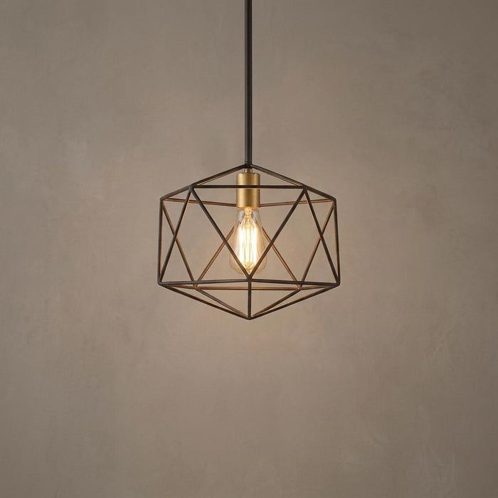 Geometric matte bronze pendant light with an open wire cage and warm glowing Edison bulb against a neutral wall.