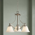 Hinkley Bolla 3-light brushed nickel chandelier with frosted glass shades hanging against a green wall.