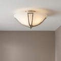 Hinkley Bolla brushed nickel flush ceiling light with an opal glass bowl shade glowing on a white ceiling.