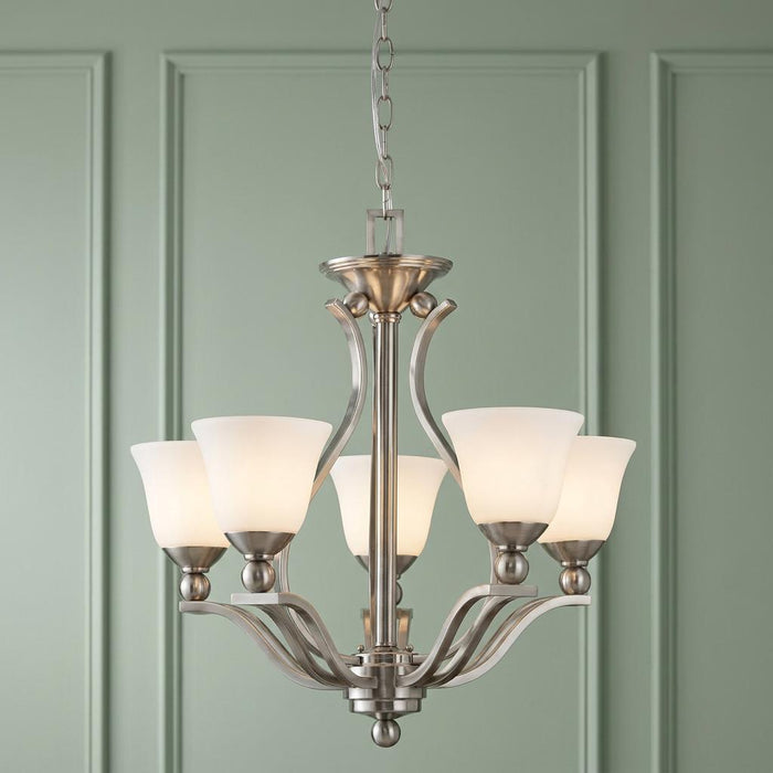Hinkley Bolla brushed nickel 5-light chandelier with frosted opal shades against a light green paneled wall.