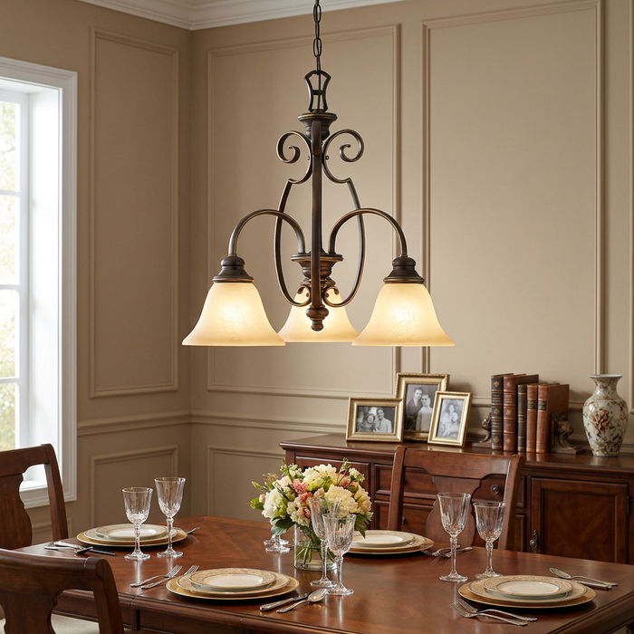 Antique bronze 3-light chandelier with frosted glass shades hanging over a set dining room table.