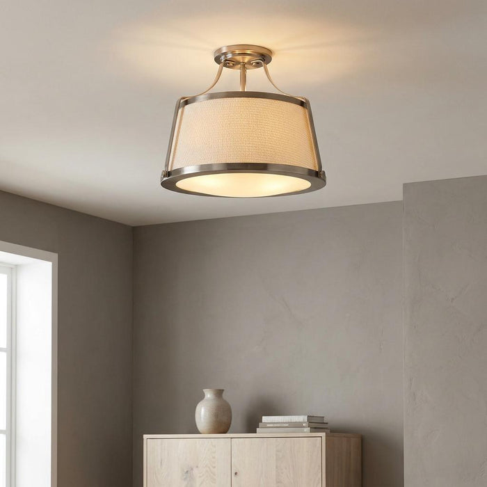 Hinkley Charlotte semi-flush ceiling light with antique nickel finish and linen drum shade in a modern room.