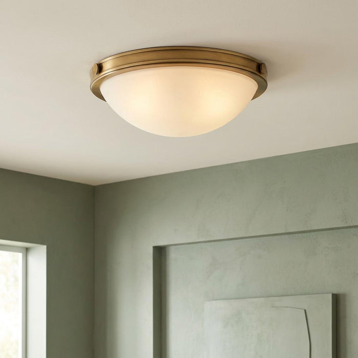 Hinkley Collier 2 Light Small Flush Brass Ceiling Light with a frosted glass dome on a white ceiling.