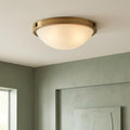 Hinkley Collier 2 Light Small Flush Brass Ceiling Light with a frosted glass dome on a white ceiling.