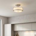 Polished chrome semi-flush ceiling light with opal glass shades mounted in a contemporary kitchen.