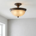 Hinkley Mayflower bronze semi-flush ceiling light with an amber glass bowl shade mounted on a white ceiling.