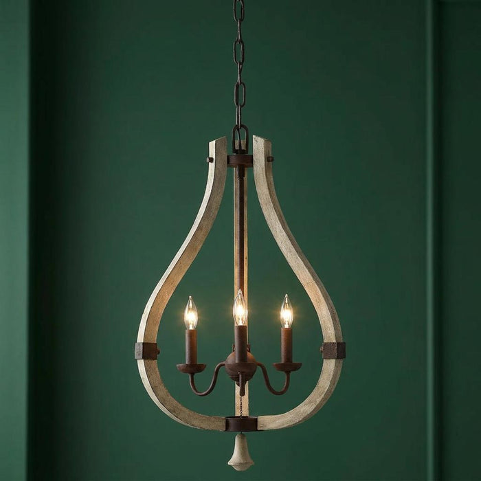 Three-light chandelier with a distressed wood teardrop frame and iron accents against a dark green wall.