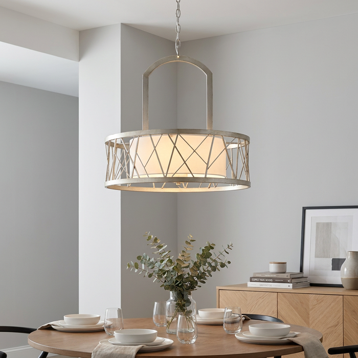 Silver leaf pendant chandelier with a geometric cage design hanging above a set dining table in a modern room.