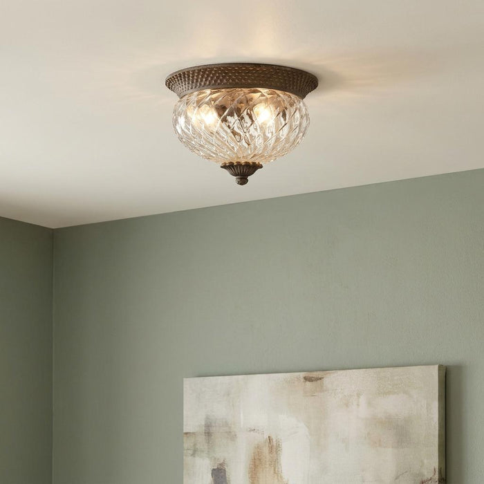 Hinkley Plantation pearl bronze flush ceiling light with optic glass shade mounted on a white ceiling.